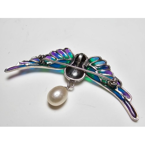 175 - A stunning 925 silver pique a jour bird formed brooch featuring colourful stained glass backing to t... 