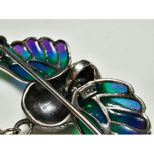 175 - A stunning 925 silver pique a jour bird formed brooch featuring colourful stained glass backing to t... 