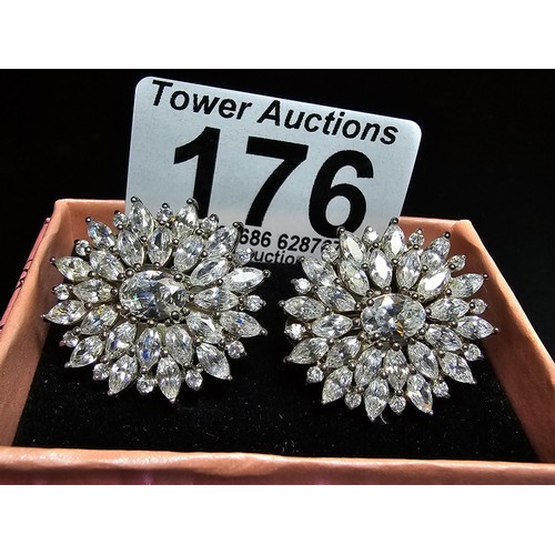 176 - A pair of art deco style sterling silver clip on cluster earrings inset with a large quantity of CZ ... 