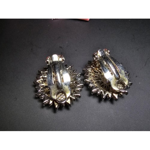 176 - A pair of art deco style sterling silver clip on cluster earrings inset with a large quantity of CZ ... 