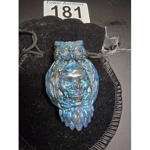 181 - A stunning carved labradorite stone specimen featuring an owl with a skull to the centre design, the... 