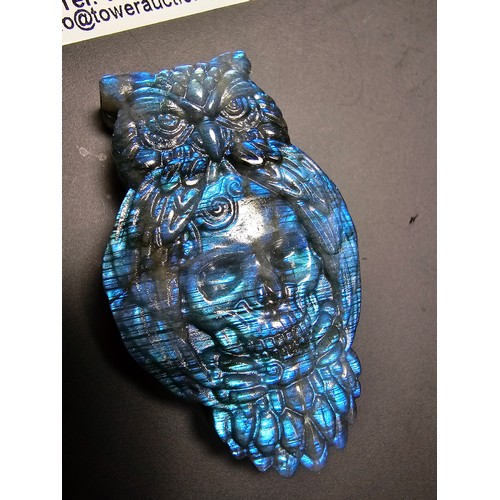 181 - A stunning carved labradorite stone specimen featuring an owl with a skull to the centre design, the... 