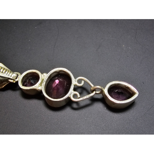 187 - An Impressive 925 silver long drop pendant inset with 3x faceted crystal purple glass stones, in exc... 