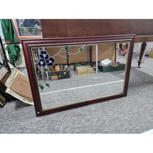 83 - A good quality mahogany framed mirror with a leaded floral design one side in good overall condition... 