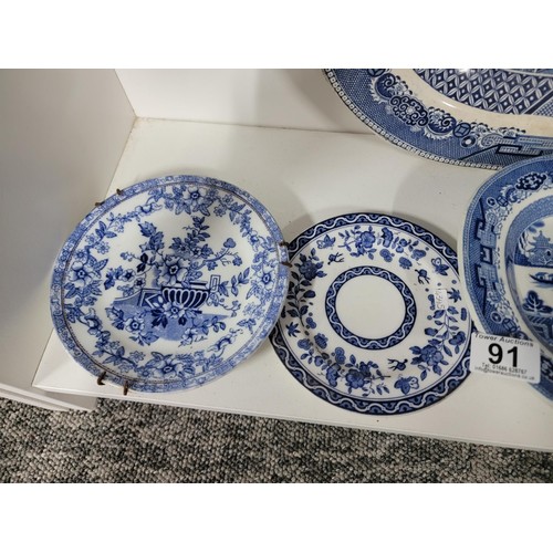 91 - Quantity of vintage blue and white plates inc Royal Doulton, Booths etc, one dish has a cip to the r... 