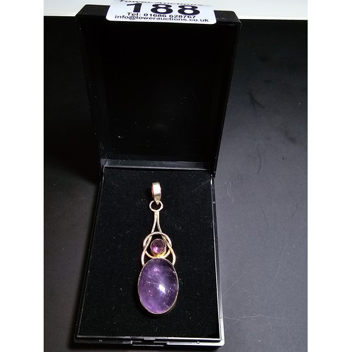 188 - A pretty 925 silver long drop pendant inset with a large natural amethyst oval stone and a round fac... 