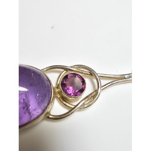 188 - A pretty 925 silver long drop pendant inset with a large natural amethyst oval stone and a round fac... 