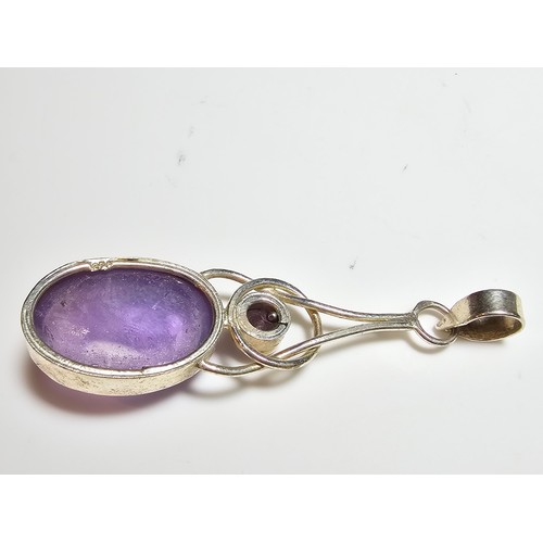 188 - A pretty 925 silver long drop pendant inset with a large natural amethyst oval stone and a round fac... 