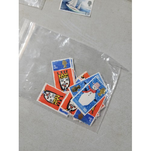 124 - Tub containing a large quantity of bagged pre decimal British commemorative stamps mint stamps have ... 