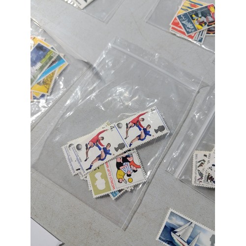 124 - Tub containing a large quantity of bagged pre decimal British commemorative stamps mint stamps have ... 