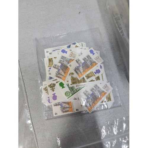 124 - Tub containing a large quantity of bagged pre decimal British commemorative stamps mint stamps have ... 