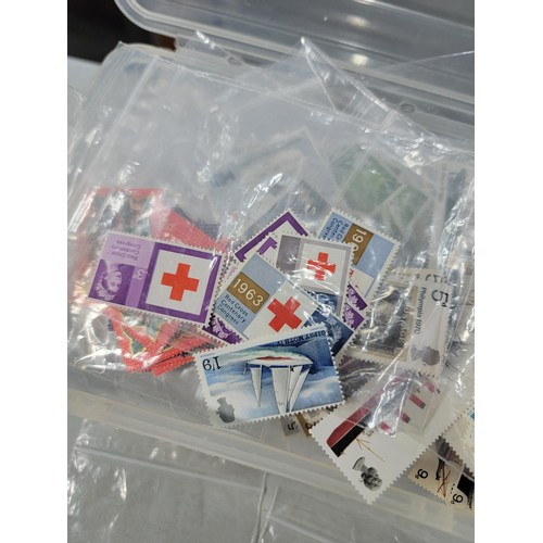 124 - Tub containing a large quantity of bagged pre decimal British commemorative stamps mint stamps have ... 