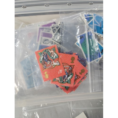 124 - Tub containing a large quantity of bagged pre decimal British commemorative stamps mint stamps have ... 