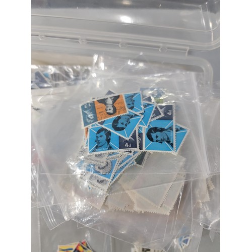 124 - Tub containing a large quantity of bagged pre decimal British commemorative stamps mint stamps have ... 