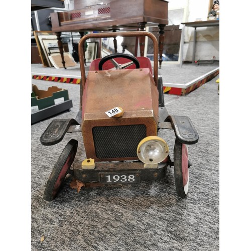 148 - A vintage model child's pedal car missing a front wheel in need of restoration, car measures 48cm hi... 