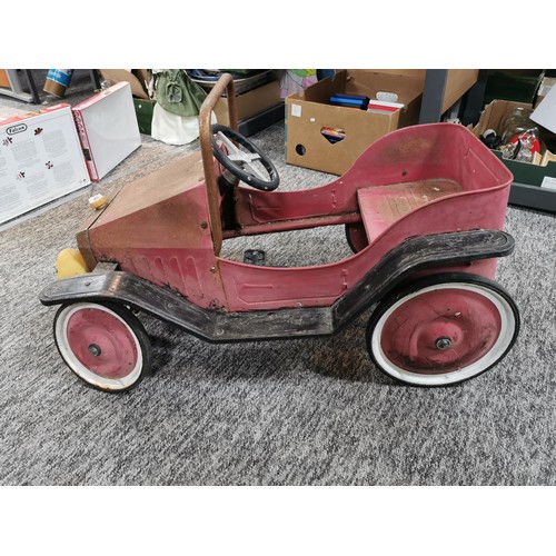 148 - A vintage model child's pedal car missing a front wheel in need of restoration, car measures 48cm hi... 