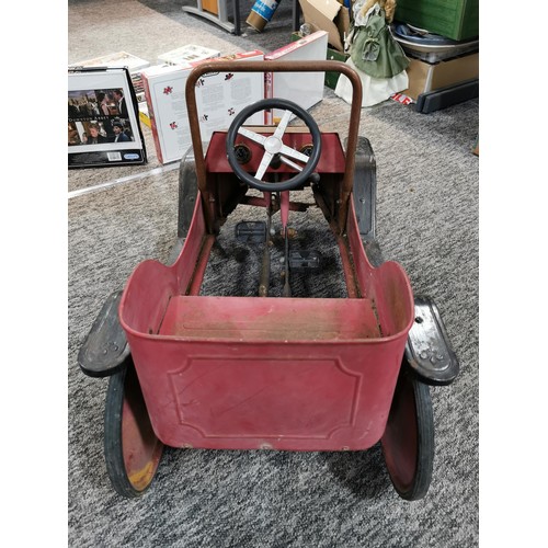 148 - A vintage model child's pedal car missing a front wheel in need of restoration, car measures 48cm hi... 