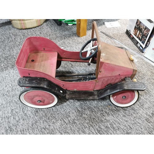 148 - A vintage model child's pedal car missing a front wheel in need of restoration, car measures 48cm hi... 