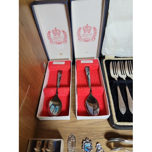 131 - Shelf full of a large quantity of plated ware inc boxed cake forks with serving fork, teaspoons, but... 