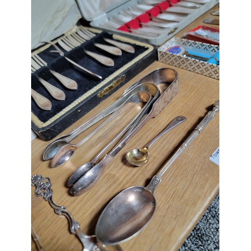 131 - Shelf full of a large quantity of plated ware inc boxed cake forks with serving fork, teaspoons, but... 