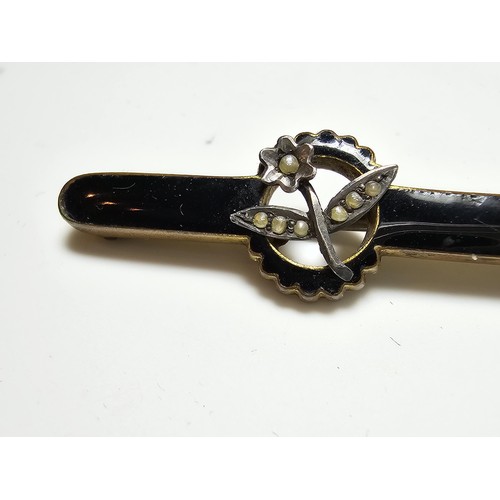 213 - A good antique Victorian mourning brooch with black enamel having a silver flower to the centre inse... 