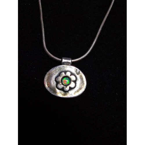 216 - A pretty 925 silver necklace and pendant by Pia, the pendant has a flower design inset with a beauti... 