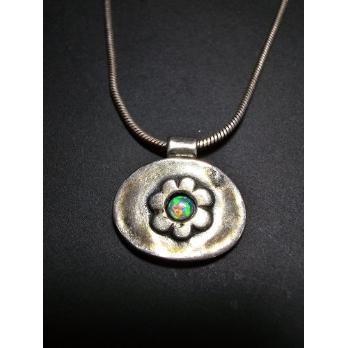 216 - A pretty 925 silver necklace and pendant by Pia, the pendant has a flower design inset with a beauti... 