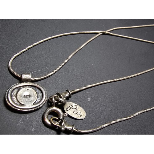 216 - A pretty 925 silver necklace and pendant by Pia, the pendant has a flower design inset with a beauti... 