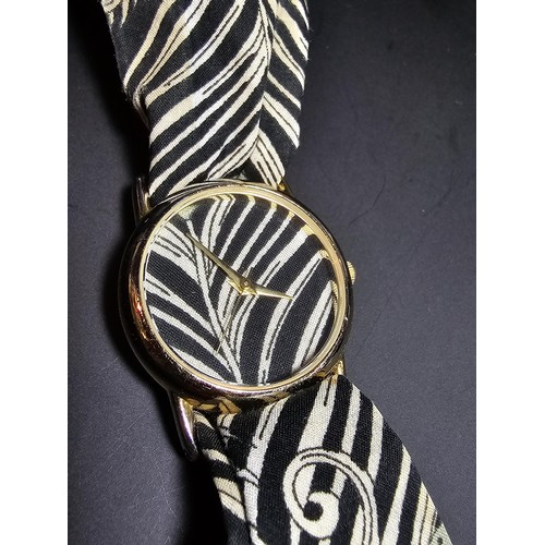 219 - An attractive genuine Liberty of London scarf watch featuring a peacock feather design, having a fab... 