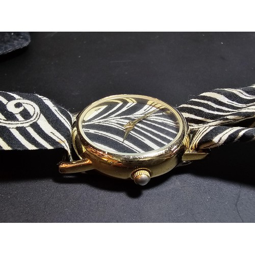 219 - An attractive genuine Liberty of London scarf watch featuring a peacock feather design, having a fab... 