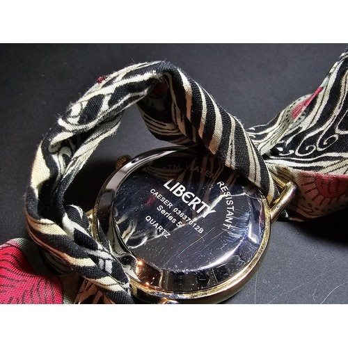 219 - An attractive genuine Liberty of London scarf watch featuring a peacock feather design, having a fab... 