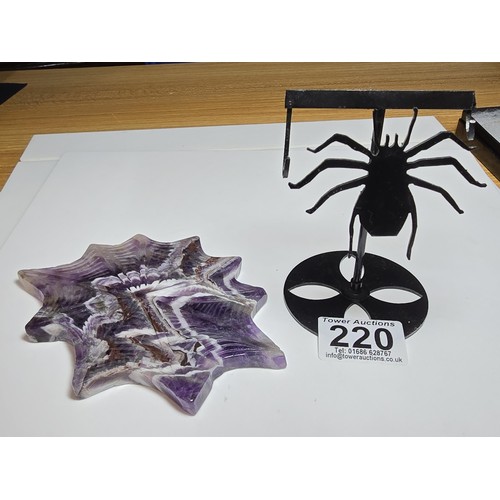 220 - An unusual crystal ornament of a large carved natural amethyst cobweb which sits on a black metal st... 