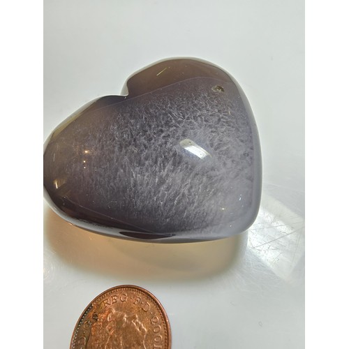 229 - A large carved chalcedony hard stone heart presenting a good natural translucent colour and grain, p... 