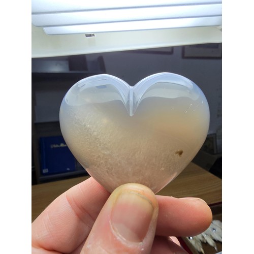 229 - A large carved chalcedony hard stone heart presenting a good natural translucent colour and grain, p... 