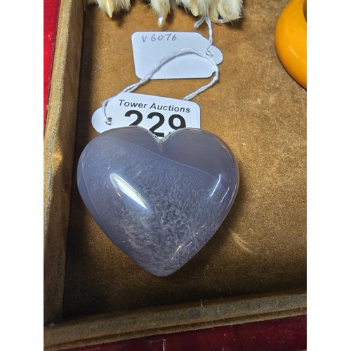 229 - A large carved chalcedony hard stone heart presenting a good natural translucent colour and grain, p... 