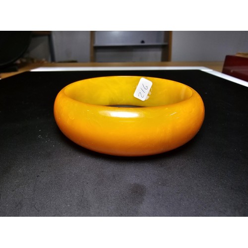 229C - A good quality genuine solid butterscotch amber carved bangle presenting an excellent natural swirle... 