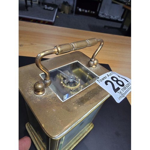 281 - A good quality antique brass cased carriage clock featuring a porcelain dial and bevelled glass view... 