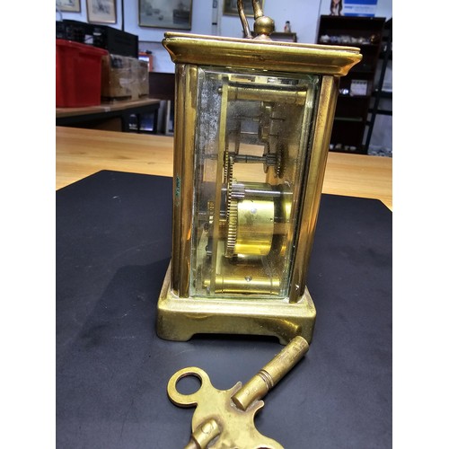 281 - A good quality antique brass cased carriage clock featuring a porcelain dial and bevelled glass view... 