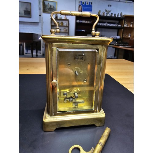 281 - A good quality antique brass cased carriage clock featuring a porcelain dial and bevelled glass view... 