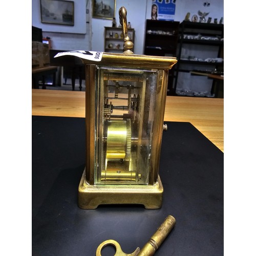 281 - A good quality antique brass cased carriage clock featuring a porcelain dial and bevelled glass view... 