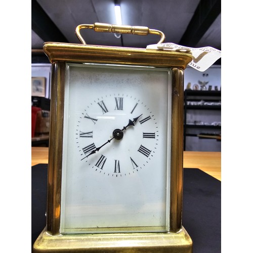 281 - A good quality antique brass cased carriage clock featuring a porcelain dial and bevelled glass view... 