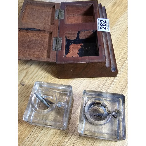 282 - A good vintage art deco double inkwell set fitted in a stepped solid mahogany inkwell box, both glas... 