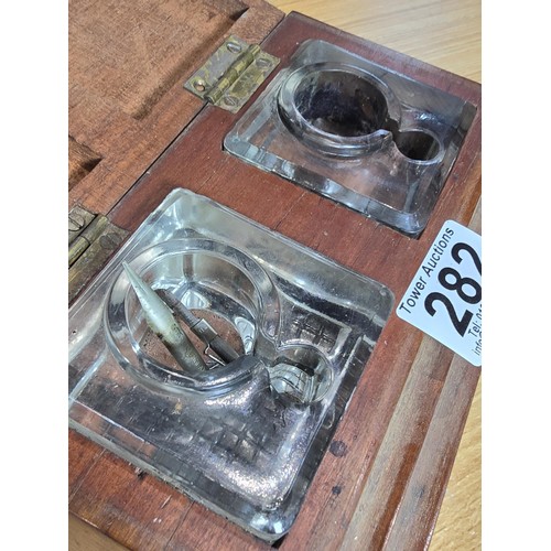 282 - A good vintage art deco double inkwell set fitted in a stepped solid mahogany inkwell box, both glas... 