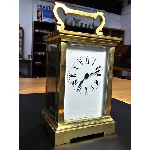 283 - A good quality antique brass cased carriage clock featuring thick gauge brass panels having a porcel... 