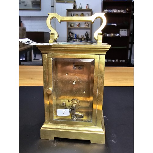 283 - A good quality antique brass cased carriage clock featuring thick gauge brass panels having a porcel... 