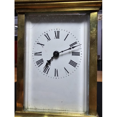 283 - A good quality antique brass cased carriage clock featuring thick gauge brass panels having a porcel... 