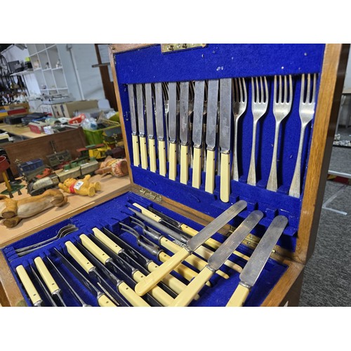 292 - A fine quality and impressive oak cased canteen of cutlery for 12 places by Walker & Hall, all but t... 