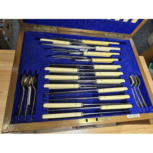 292 - A fine quality and impressive oak cased canteen of cutlery for 12 places by Walker & Hall, all but t... 