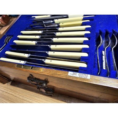 292 - A fine quality and impressive oak cased canteen of cutlery for 12 places by Walker & Hall, all but t... 