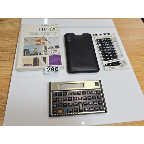 296 - A Hewlett Packard HP-12C business financial calculator in gold and black, complete with its original... 